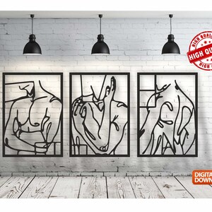May include: Three black metal wall art pieces featuring abstract line drawings of a person's torso. The art pieces are framed in black and are displayed on a white brick wall.