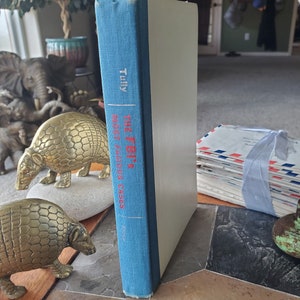 May include: A blue hardcover book titled "The FBI's Most Famous Cases" by  John  O'Connell. The book is standing upright on a table.