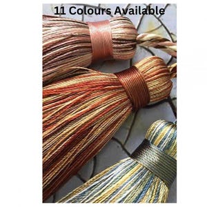 May include: Three tassel trims in different colours: a pink and white striped tassel, a brown and cream striped tassel, and a blue and cream striped tassel. 11 Colours Available.