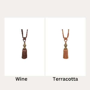 May include: Two curtain tiebacks with tassels, one in wine and one in terracotta.