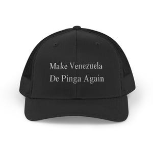 May include: Black trucker hat with a mesh back and a curved brim. The hat features the embroidered text "Make Venezuela De Pinga Again" in white, centered on the front panel. The hat is designed with a classic trucker style.