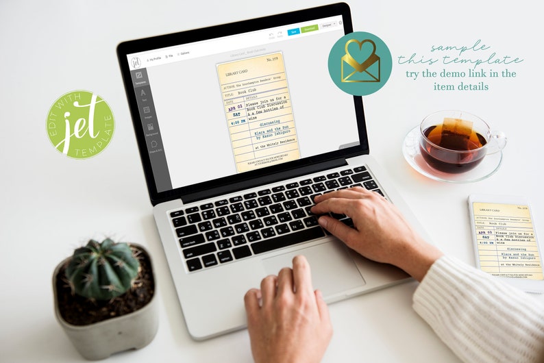 May include: A laptop screen shows a vintage library card template. A cup of tea and a small succulent plant sit on a white surface. The text "sample this template try the demo link in the item details" is visible.