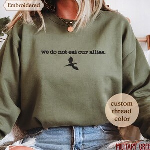 a woman wearing a sweatshirt that says we do not eat our allies
