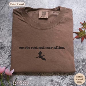 a t - shirt with the words we do not eat our allies on it