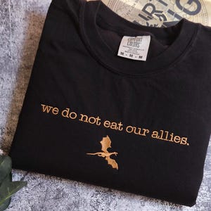 a t - shirt that says we do not eat our alles