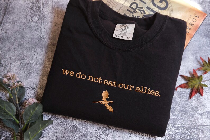a t - shirt that says we do not eat our alles