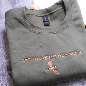 a t - shirt that says we do not eat our aliens