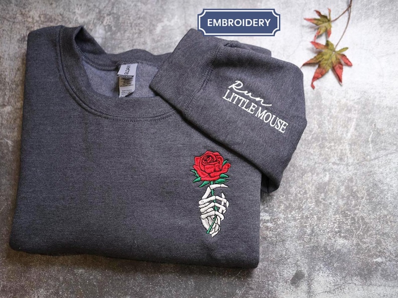 a t - shirt with a rose embroidered on it