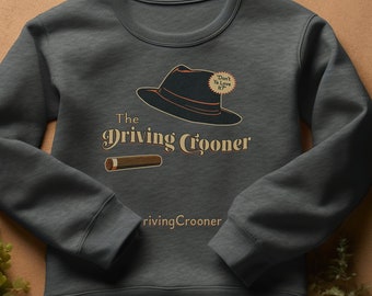 May include: Dark gray sweatshirt with a graphic that reads "The Driving Crooner" with a fedora, cigar, and the phrase "Don't Ya Love It?". The sweatshirt is made of a soft material.