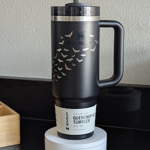 A black 30oz Stanley tumbler that features an arrangement of bats that dynamically avoid the Stanley Logo.