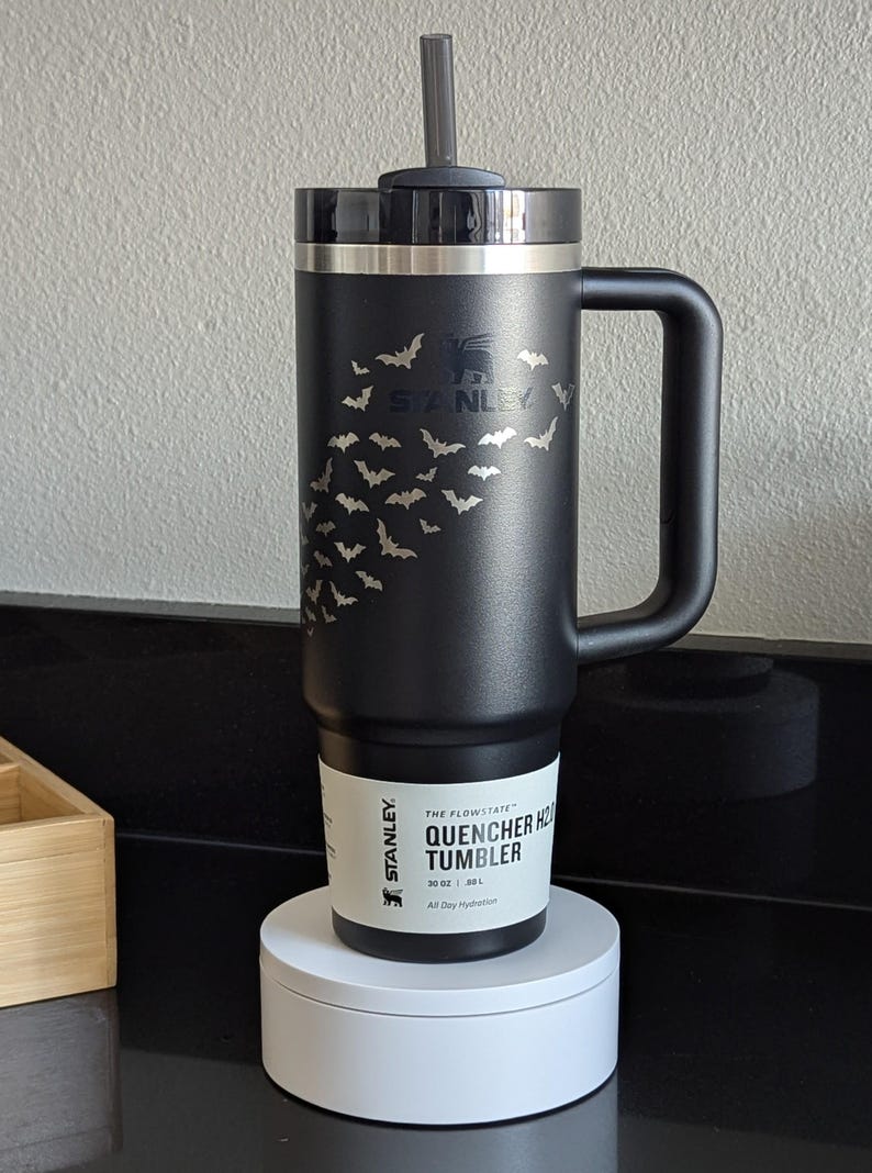 A black 30oz Stanley tumbler that features an arrangement of bats that dynamically avoid the Stanley Logo.