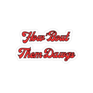 May include: Red and black sticker with the text "How 'Bout Them Dawgs" in a stylized font.