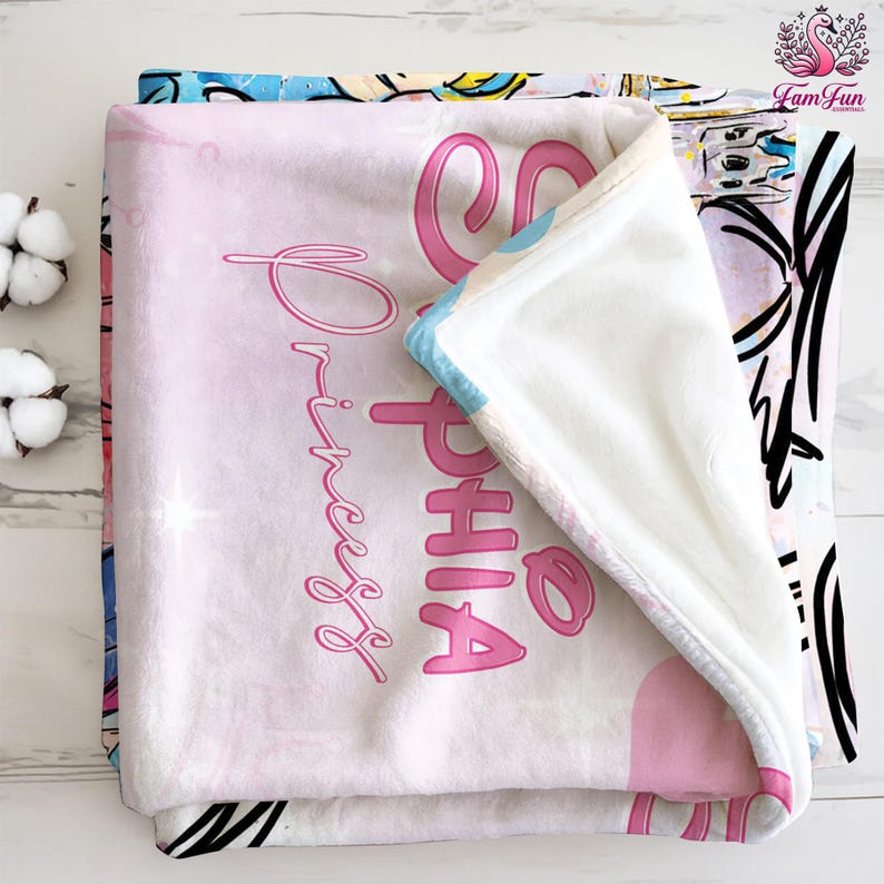 A pink and white blanket with the name "Sophia" printed on it, along with the text "Princess" written in pink.