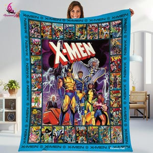 May include: A blue and white blanket with a collage of X-Men comic book covers. The center of the blanket features a large image of the X-Men characters, including Wolverine, Cyclops, Storm, and Jean Grey. The text "X-Men" is printed in large, bold letters at the top of the blanket.