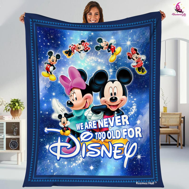 May include: A blue fleece blanket with a galaxy print and a Mickey Mouse and Minnie Mouse design. The blanket features the text "We are never too old for Disney".