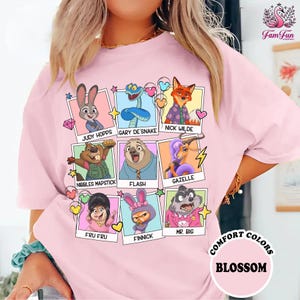 A woman wearing a pink t-shirt with a collage of cartoon character portraits and text.