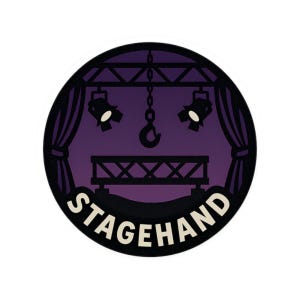 May include: A round sticker with a stage design. The sticker features a purple background with a stage, spotlights, and curtains. The word "STAGEHAND" is written in white letters.