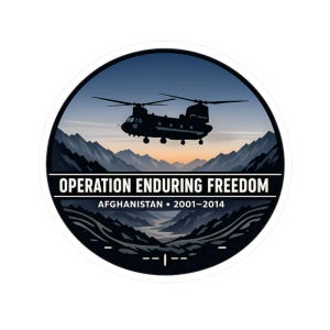 May include: A circular sticker featuring a silhouette of a Chinook helicopter flying over a mountain range at sunset. The text reads "OPERATION ENDURING FREEDOM AFGHANISTAN 2001-2014".