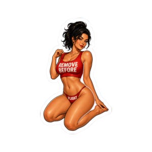 May include: A die-cut sticker featuring an illustration of a person with dark hair in a ponytail, wearing a red crop top with the white text REMOVE BEFORE and matching red bikini bottoms with the white text FLIGHT, kneeling in a pose.