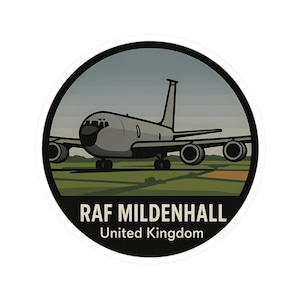 May include: A circular sticker featuring a gray airplane on a green and tan airfield under a gray sky. The text "RAF Mildenhall United Kingdom" is printed in white and black.