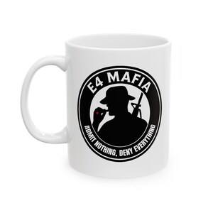 May include: White ceramic mug with a black and white graphic. The graphic features a silhouette of a person in a fedora holding a cigarette and a rifle, with the text "E4 MAFIA" and "ADMIT NOTHING, DENY EVERYTHING" in a circular design.