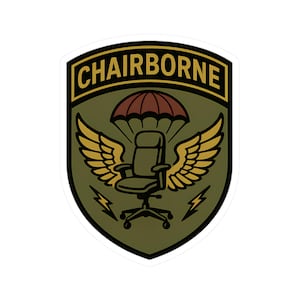 May include: A sticker with a shield design featuring the word "CHAIRBORNE" in a gold font. The design includes a brown parachute, a chair, gold wings, and lightning bolts on a green background.