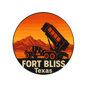May include: A circular sticker featuring a black silhouette of a military vehicle with a raised platform, set against a sunset backdrop of orange and yellow hues. The text "FORT BLISS Texas" is displayed in a bold, stylized font.