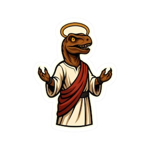 Puede incluir: Una pegatina con un dinosaurio de dibujos animados con un halo, vestido con una túnica blanca y una faja roja. El dinosaurio es marrón y tiene los brazos extendidos. El diseño es de estilo caricatura.