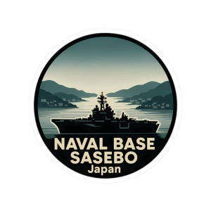May include: A round sticker featuring a stylized illustration of a naval ship in a harbor, with mountains in the background. The text "NAVAL BASE SASEBO Japan" is printed below the image in a bold, sans-serif font. The sticker has a white border.