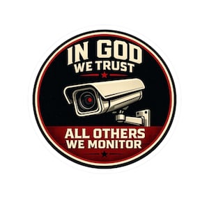 May include: A circular sticker with a security camera graphic. The text "IN GOD WE TRUST" is above the camera, and "ALL OTHERS WE MONITOR" is below. The design has a black background with red and white borders and text.