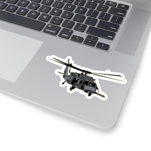 May include: A black and gray helicopter silhouette sticker. The helicopter is flying with its blades spinning.
