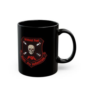 May include: Black ceramic mug featuring a red and white graphic. The graphic includes a skull, fuel canisters, and the text "Without Fuel, Pilots Are Pedestrians" and "POL". The mug has a curved handle.