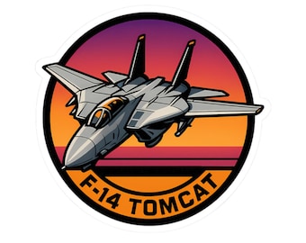 May include: A sticker featuring a stylized F-14 Tomcat fighter jet in shades of gray, set against a sunset gradient of orange, yellow, and purple. The text "F-14 TOMCAT" is displayed in white.