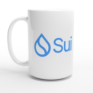 Pode incluir: Uma caneca de cerâmica branca com um logótipo gráfico azul de uma gota de água estilizada contendo uma curva em forma de S, seguido pelo texto Sui numa fonte azul sem serifas. A caneca tem um acabamento liso e uma pega curva lateral.