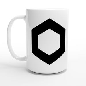 May include: White ceramic mug with a black geometric hexagon design. The mug has a large handle and a cylindrical shape. The black hexagon is centered on the mug's surface. The mug is suitable for hot or cold beverages.