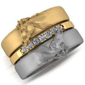 May include: Three rings stacked together. The top ring is gold with a horse head design. The middle ring is gold with a row of clear stones. The bottom ring is silver with a horse head design.