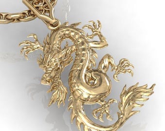 May include: A gold-colored dragon pendant with intricate details, suspended from a matching chain. The dragon is depicted in a dynamic pose, with detailed scales and claws. The pendant is likely made of metal and is suitable for jewelry.