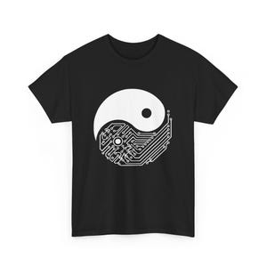 May include: Black t-shirt with a white Yin and Yang design. The symbol is styled with a circuit board pattern. The shirt has a crew neck. The design is a modern take on a classic philosophical concept.