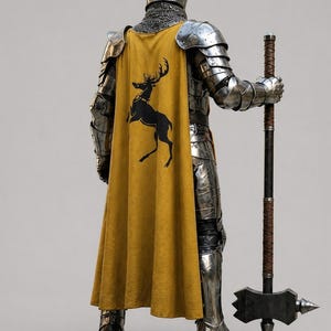 May include: A suit of polished steel plate armor featuring a chainmail coif and a long mustard yellow cape. The cape displays a black silhouette of a prancing stag. The figure holds a tall polearm with a dark shaft and a heavy metal hammer head.
