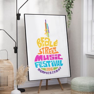 Pode incluir: Um cartaz para o Beale Street Music Festival em Memphis, Tennessee. O cartaz apresenta uma ilustração colorida de um violão com as palavras "Beale Street Music Festival 2016 Memphis in May" escritas nele.