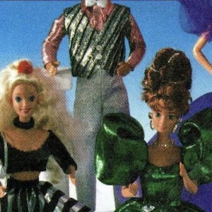 May include: Three dolls dressed in formal attire. A doll with blonde hair is wearing a silver and black striped jacket, white trousers, and a pink bow tie. A doll with blonde hair is wearing a black top and a black and white striped skirt. A doll with brown hair is wearing a green dress with a large bow on the shoulder.
