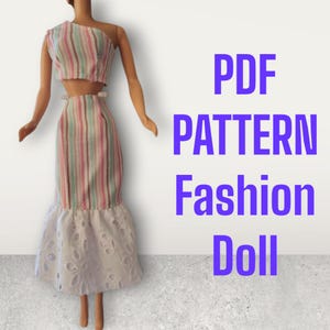 May include: PDF pattern for a doll dress. The dress is a two-piece set with a striped top and skirt. The skirt has a white lace trim.
