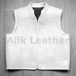 May include: White leather vest with a crocodile pattern and a zipper closure.