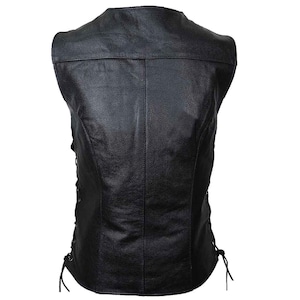 May include: Black leather vest with a classic design. The vest features a V-neck, a tailored fit, and side laces for adjustment. The back has a simple, clean design with vertical seams. A timeless piece for a biker or casual look.