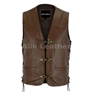 May include: A brown leather vest with a V-neck and a front closure with metal buckles. The vest has a label that says "Aiiik Leather".
