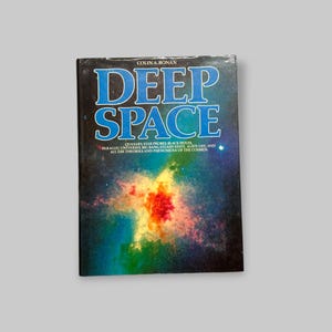 May include: A book cover with a blue background and the title "Deep Space" in white letters. The cover features a colorful nebula with a bright orange center.