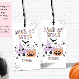 May include: Two white gift tags with black string, featuring the text "kick or treat" in orange and purple. Each tag has a soccer ball, a witch hat, and a jack-o'-lantern. The tags are decorated with bats and stars.