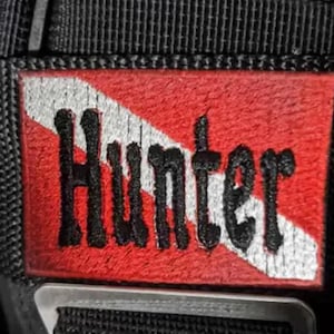 May include: Red and white scuba diving flag patch with the name "Hunter" embroidered in black.