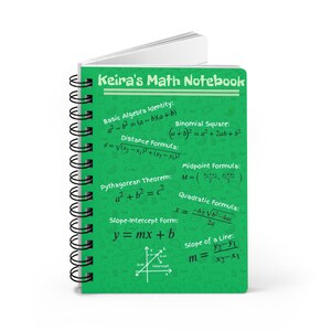 May include: A green spiral-bound notebook titled Keira's Math Notebook. The cover features white text and mathematical formulas including the Pythagorean Theorem, quadratic formula, and slope-intercept form, along with a small coordinate graph.