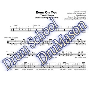 May include: A sheet music score for the song "Eyes On You" by The Belonging Co. The score is for drums and includes the lyrics for the song. The drum parts are written in standard musical notation.